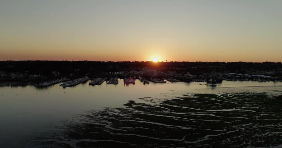 The sun shines above the water