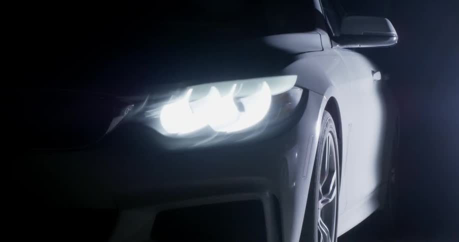 A vehicle's headlight illuminates the night