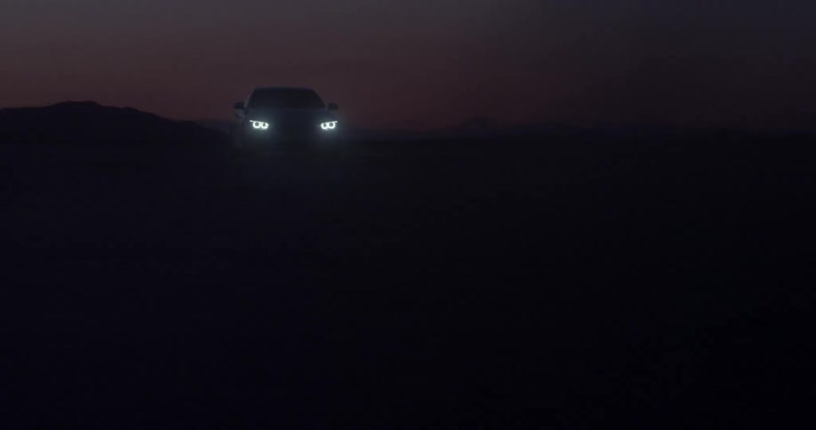 A car's headlights shine at night