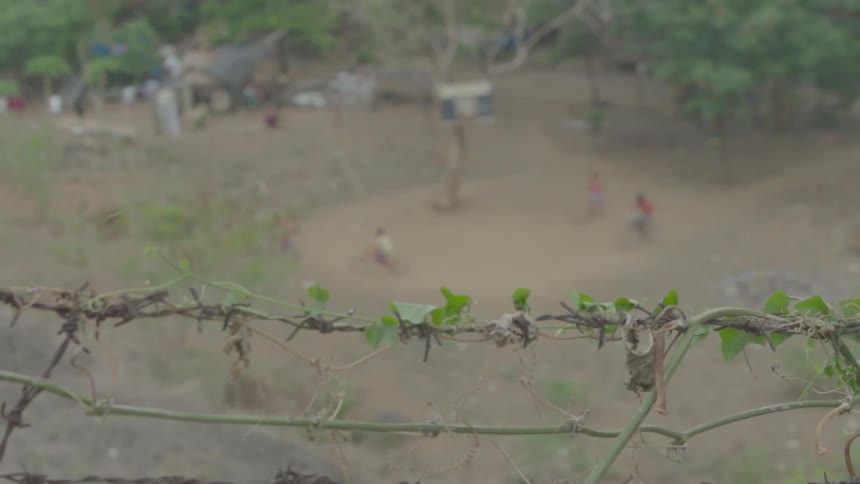 Children play in a rural dirt field