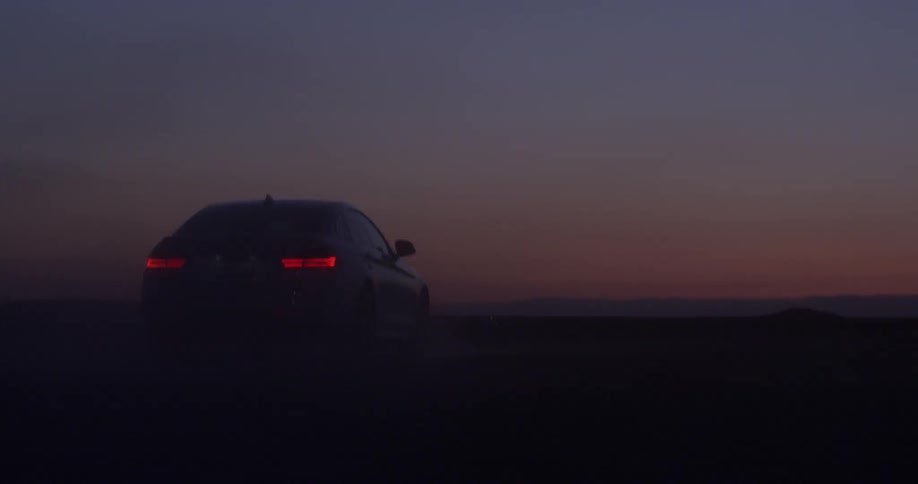 A vehicle sit still in a desert landscape at dusk