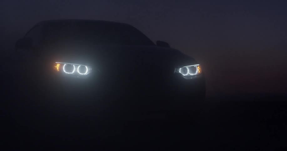 A car's headlights shine at night
