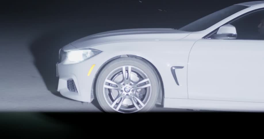 Car headlights shine in the dark