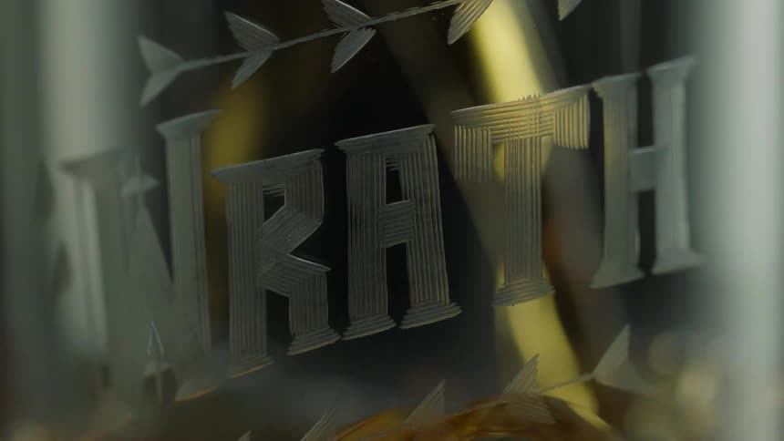 Liquid is poured into a glass labeled wrath