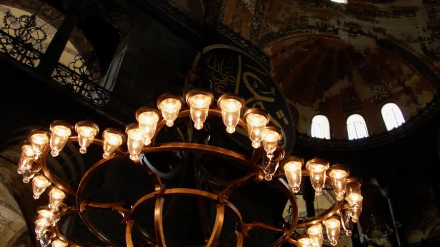 Light fixtures hang from the ceiling illuminated