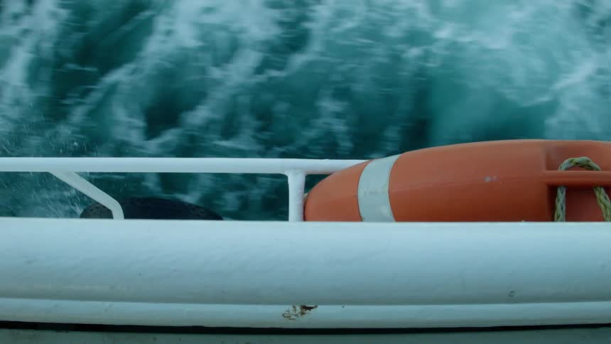 A boat travels through blue icy water