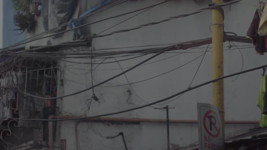 Laundry hangs from power lines and balconies
