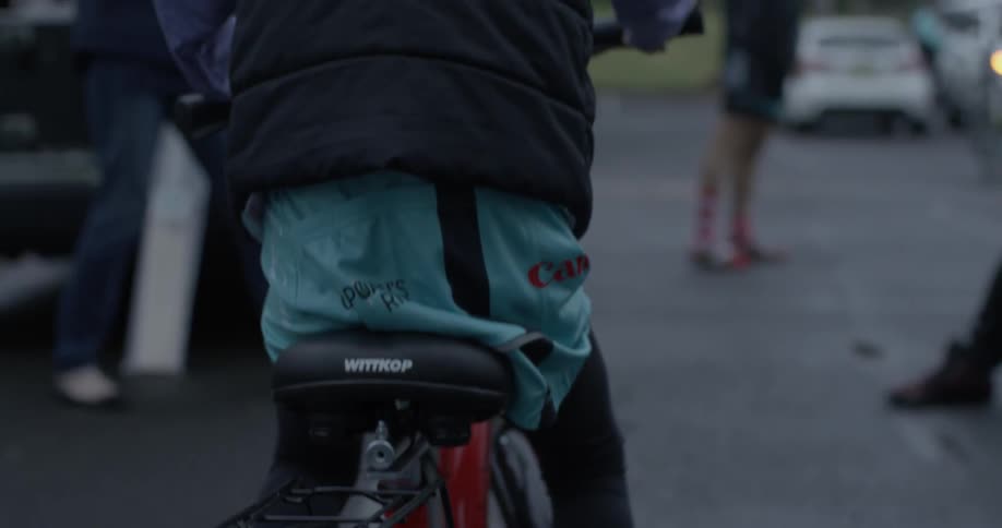 A child peddles a red bike