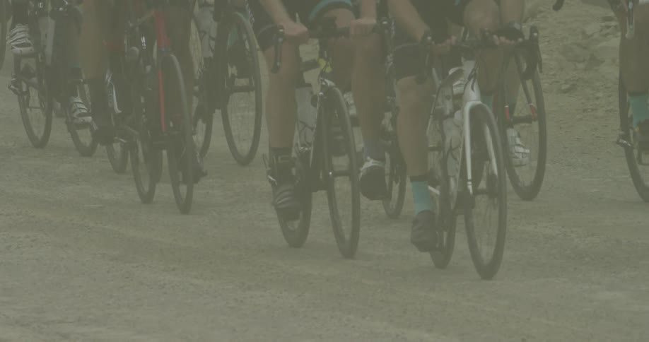 People are racing on bicycles together on the trail