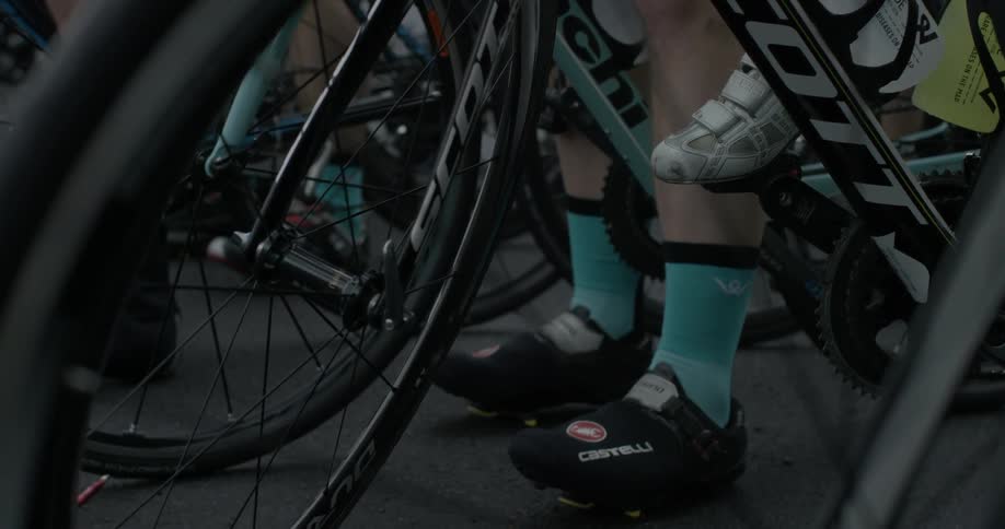 Shoe clad feet are poised on bicycles