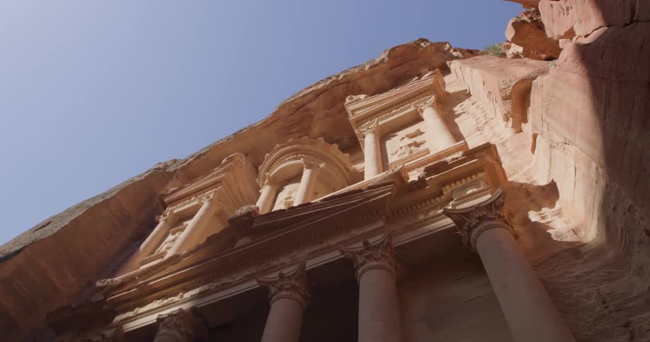 The sun shines on the side of a clay building