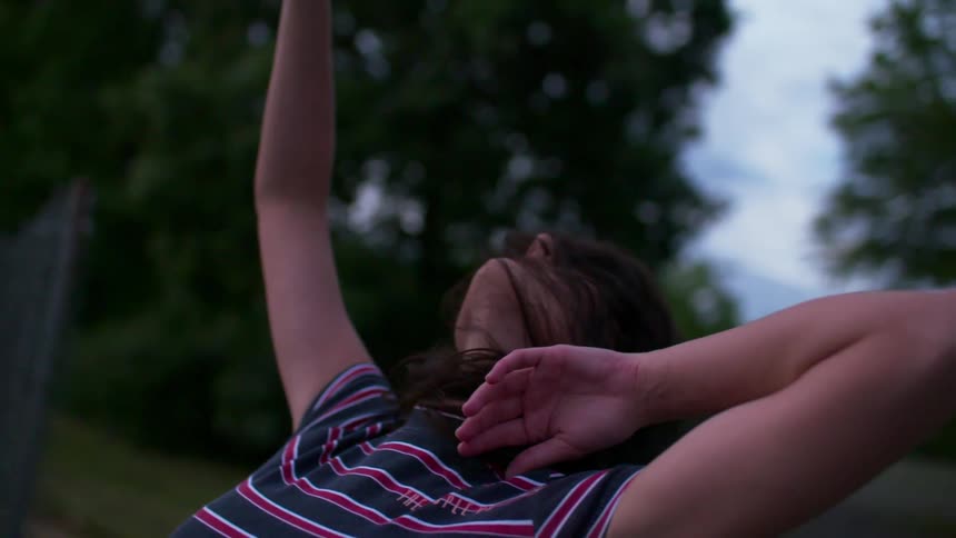 A woman in a striped shirt stretches