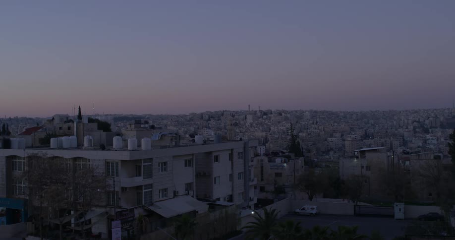 The sun is setting over the town ahead