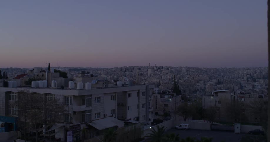 City buildings are shown at sunset