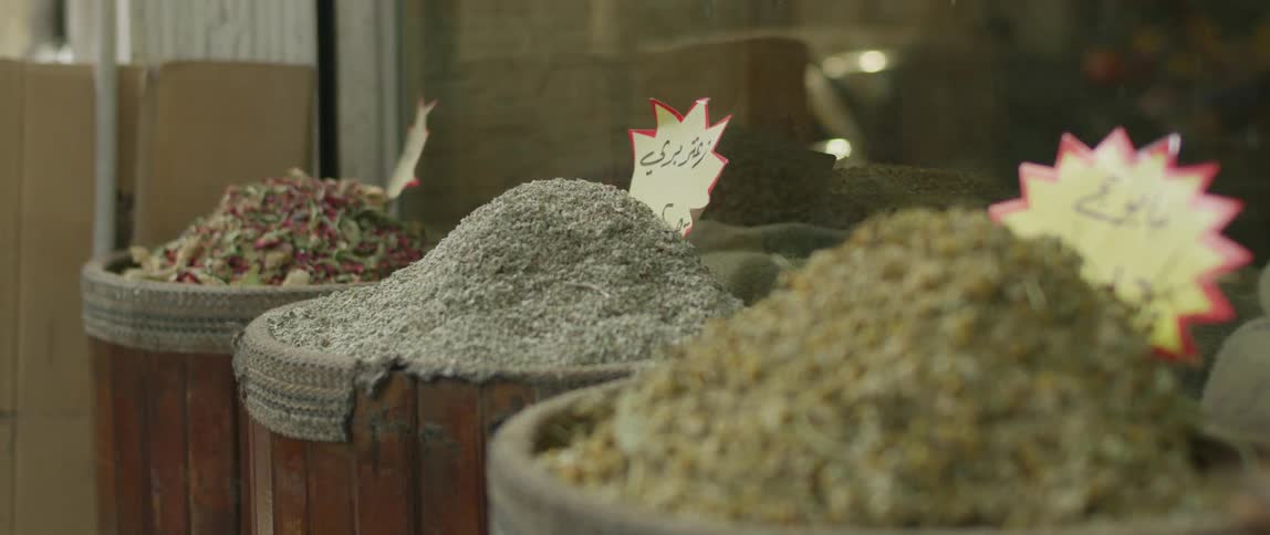 Buckets of various grains outside a building