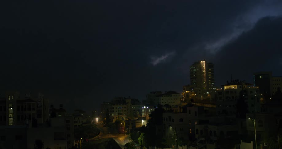 Vehicles travel on a city road at night