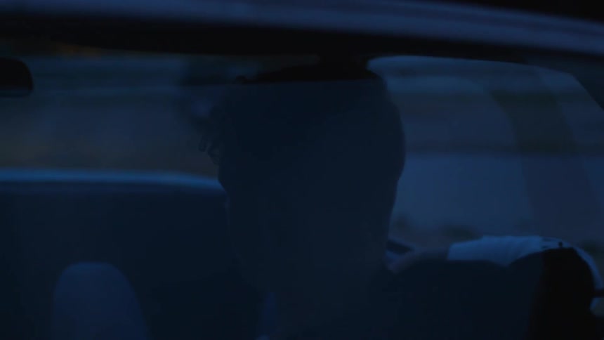 Someone riding in a car with their arm out the window