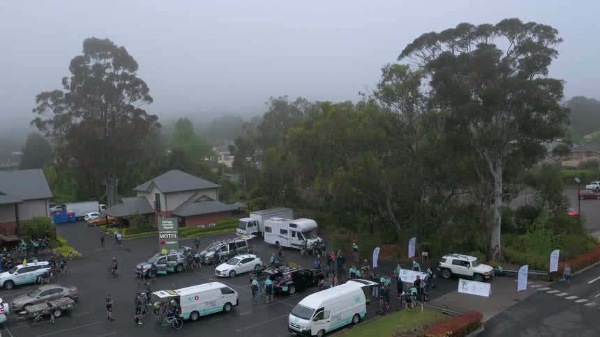 Parking lot full of people and vehicles