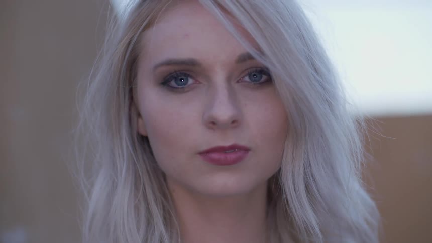 Woman with blue eyes stares intently
