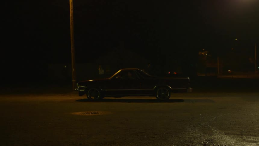 A car sits under a street light