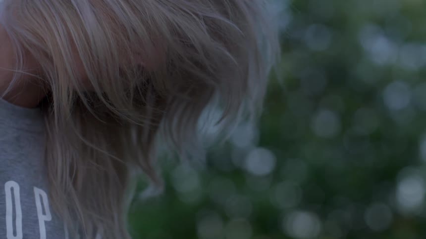 A woman whips her hair back and forth