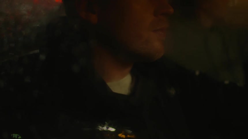 Man riding in a car at night