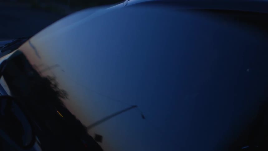 Young man sits inside a vehicle looking out
