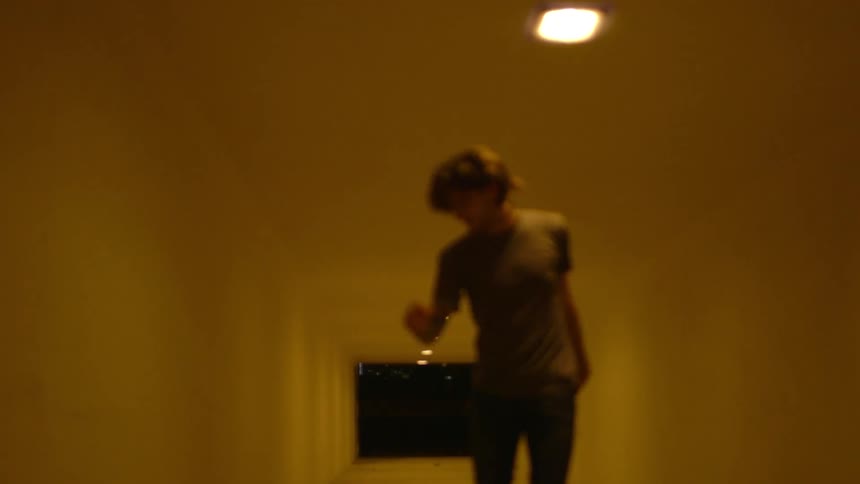A man standing in a tunnel kicks a few times in frustration