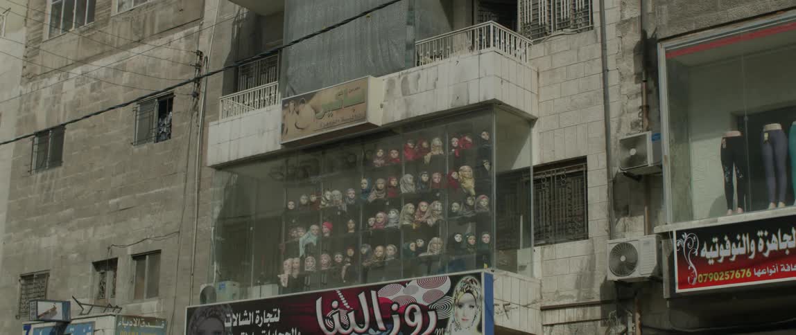 A window in a shop displays head coverings