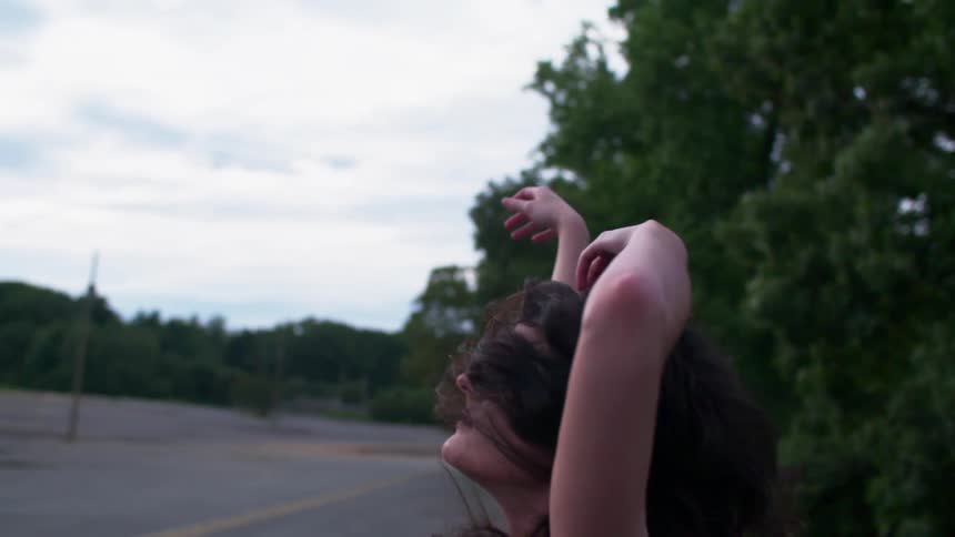 A woman dances outside