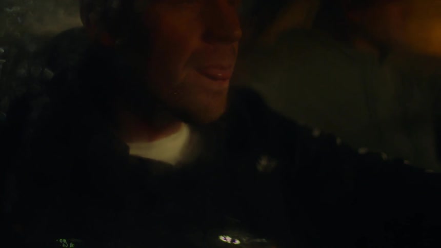 A man sits in the backseat of a car