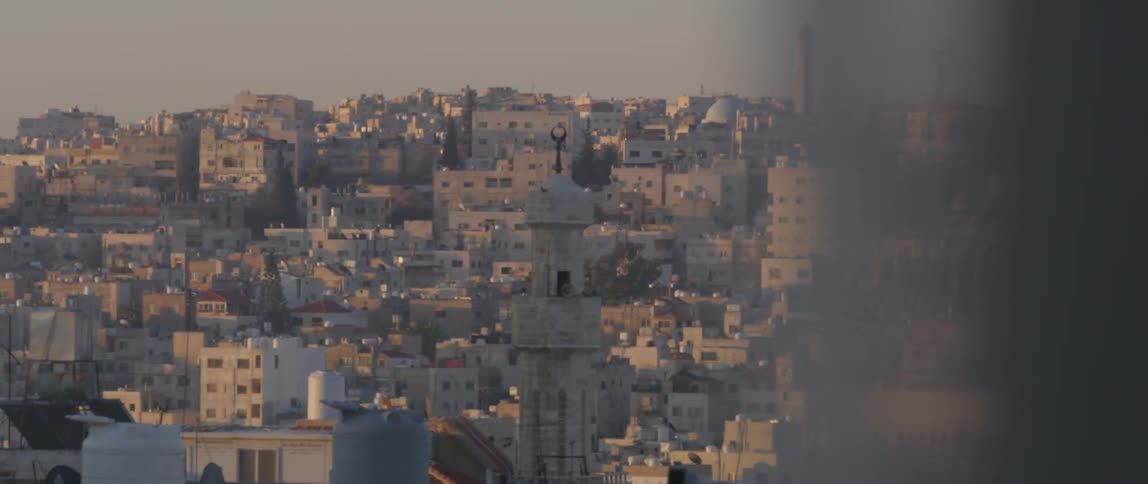 A large city is being filmed from a window