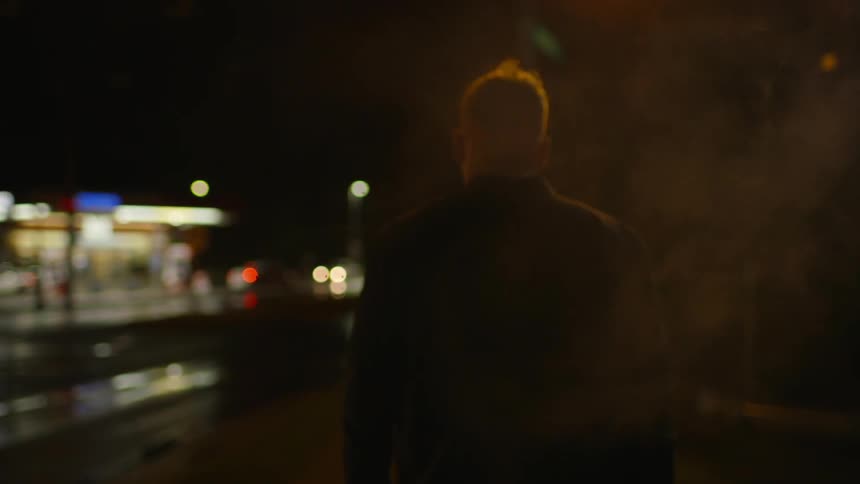 Man walking outside in the city at night