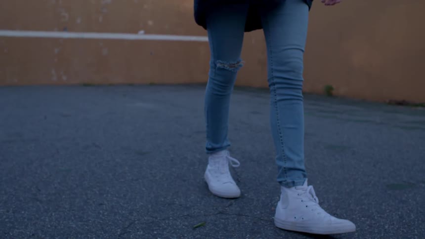 A person in white shoes is stepping backwards