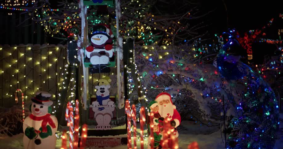 The house has many bright christmas decorations with flashing lights