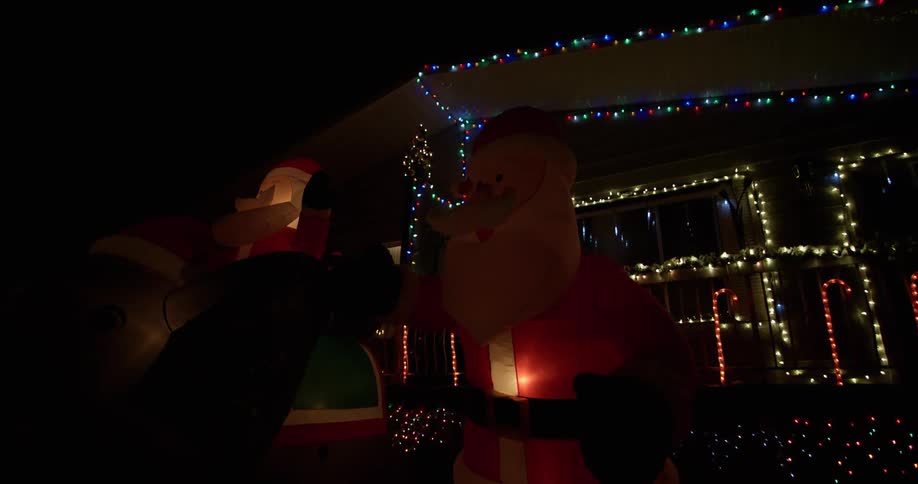 Christmas lights and decorations illuminate the night