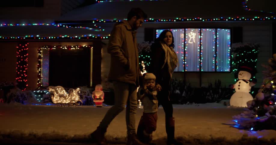 A family walks near decorated houses