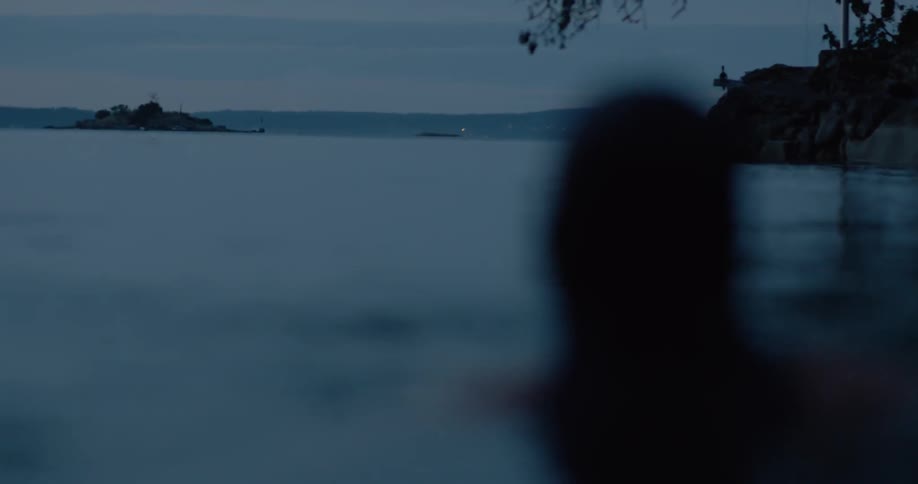 A woman is splashing in the water at sunset