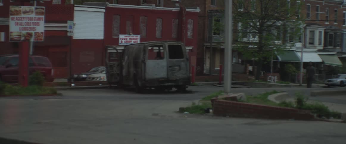 A burnt out van in a parking lot
