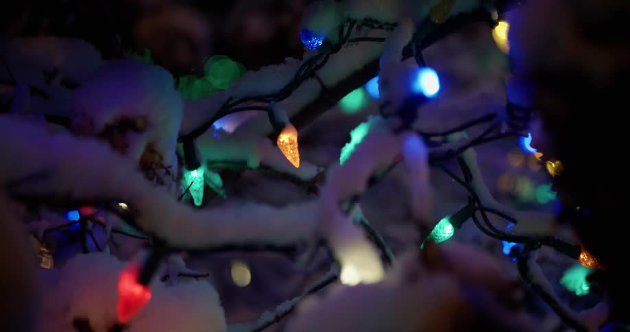 The christmas lights are blinking fast covered in snow