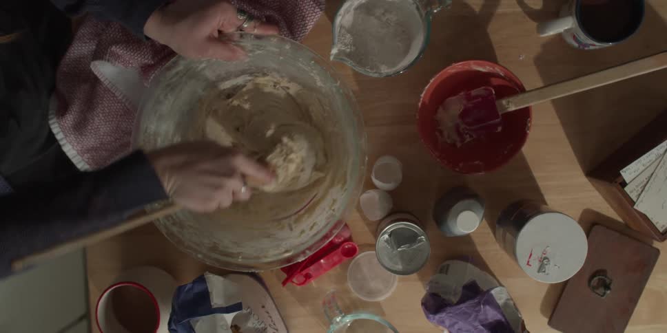 Two women mix cookie dough together
