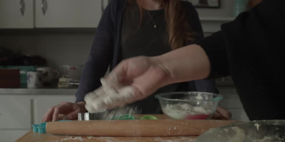 Two women prepare to bake cookies