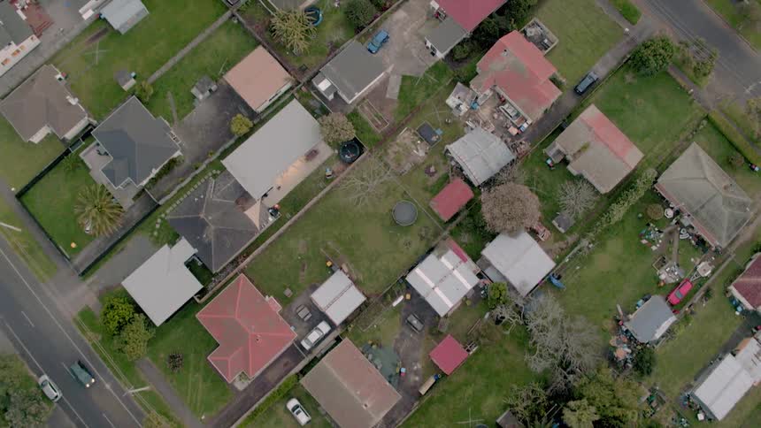 A neighborhood is being filmed from a drone
