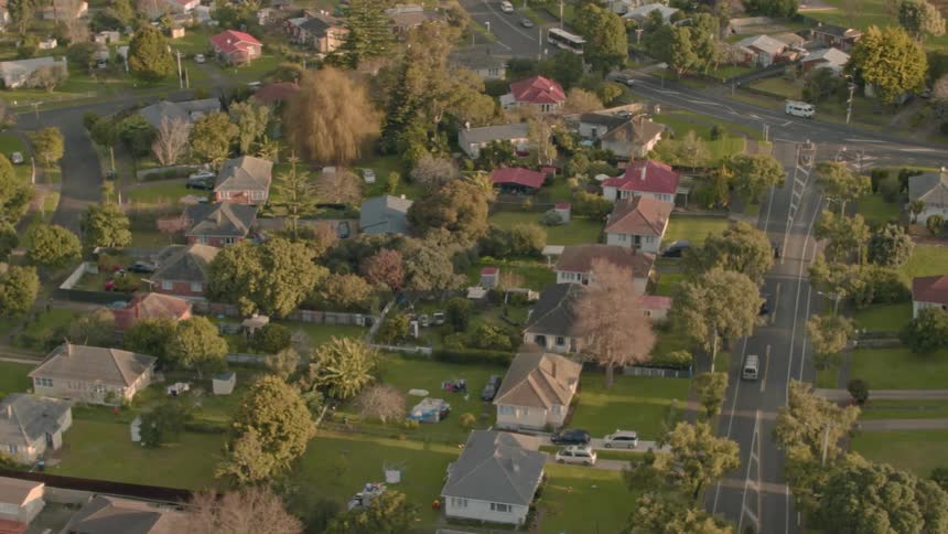 Residential houses and vehicles cover the landscape
