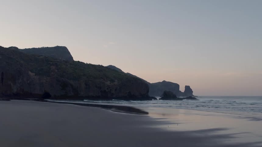 Waves flow onto the beach shore