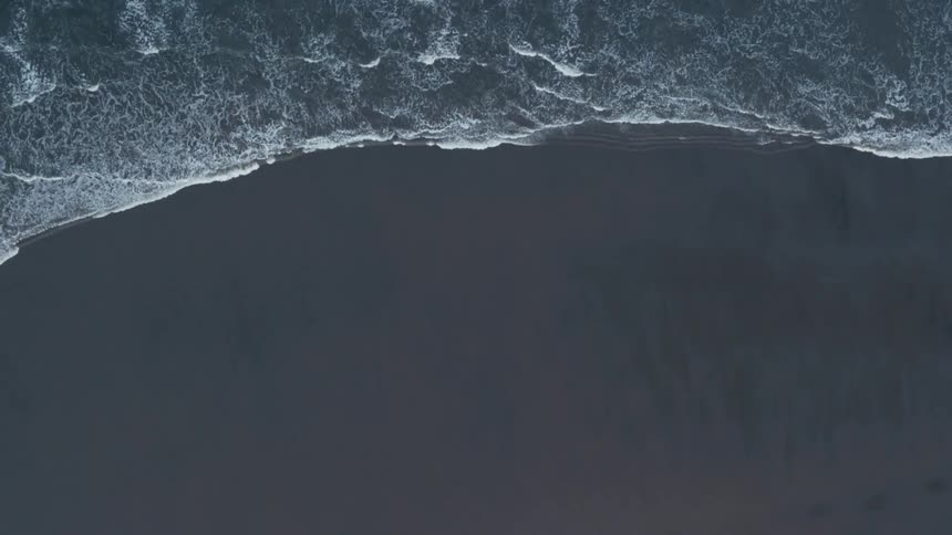Waves are crashing ashore are being filmed from a drone