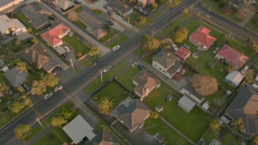 Residential houses and vehicles cover the landscape
