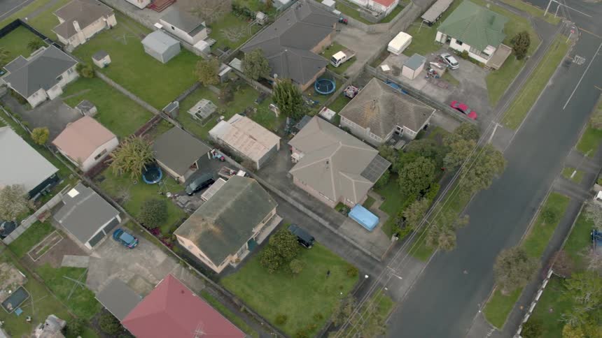 Residential houses and vehicles cover the landscape