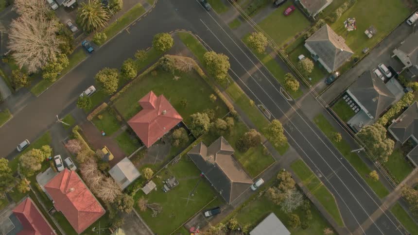 Residential houses and vehicles cover the landscape