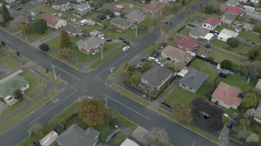 Residential houses and vehicles cover the landscape